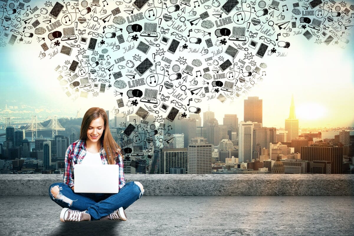 Woman on computer with icons in the background